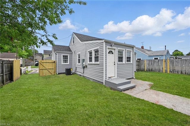 rear view of property with central AC unit