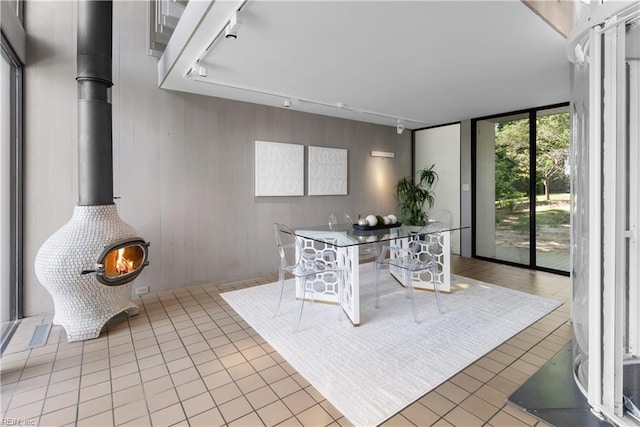 1336 Moyer Rd, Newport News, VA 23606 - tiled dining space with track lighting, a wood stove, and a wall of windows