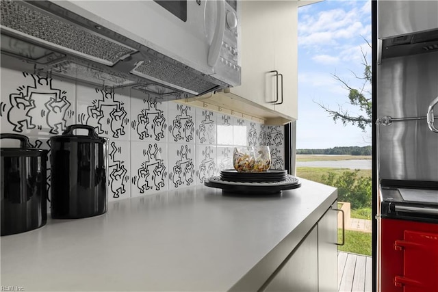 1336 Moyer Rd, Newport News, VA 23606 - kitchen featuring white microwave, healthy amount of natural light, fridge, and backsplash
