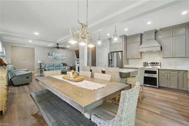 dining room featuring light wood-style flooring, ceiling fan, recessed lighting, crown molding, and baseboards