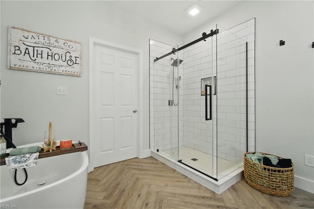 bathroom featuring a stall shower and a freestanding tub