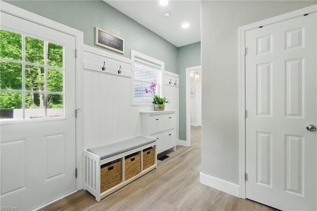 mudroom with light wood-type flooring, plenty of natural light, and baseboards