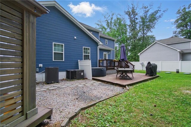 rear view of house featuring central air condition unit, a deck, and outdoor dining space