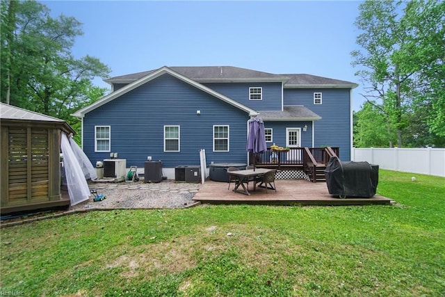 rear view of house with central AC and a deck