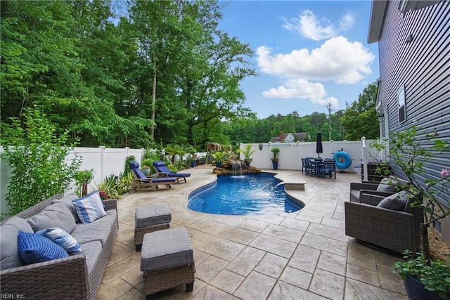 view of swimming pool featuring an outdoor living space, a patio area, and a fenced backyard
