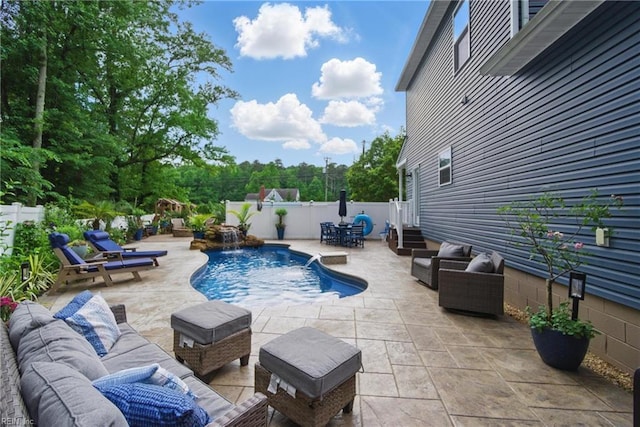 view of pool with outdoor lounge area, a patio area, and a fenced backyard