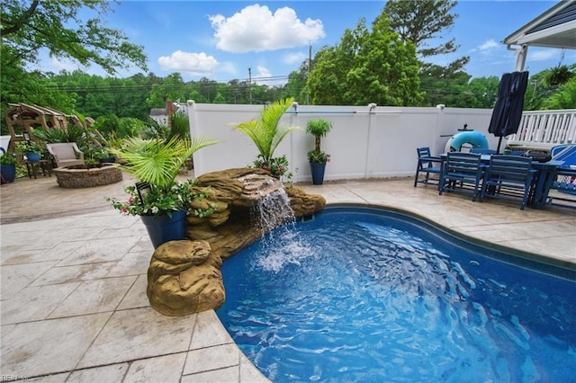 view of swimming pool featuring a patio and fence