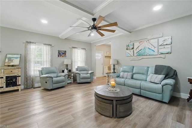 living area featuring plenty of natural light, beam ceiling, ceiling fan, wood finished floors, and baseboards