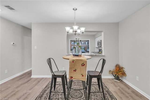3903 Lantana Pl, Virginia Beach, VA 23456 - dining room with light wood-style floors, a chandelier, and baseboards