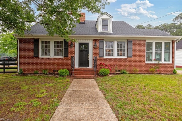 view of front of house featuring brick siding, a chimney, and a shingled roof