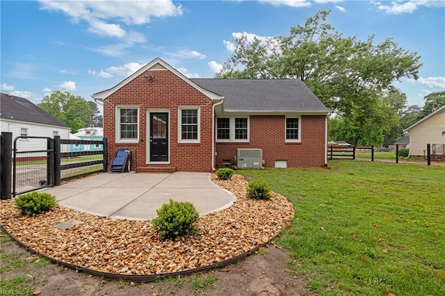 rear view of property with a gate, central air condition unit, brick siding, and a patio area