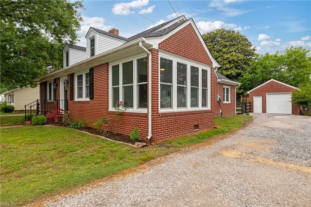 view of side of property featuring an outdoor structure, a garage, a chimney, brick siding, and driveway