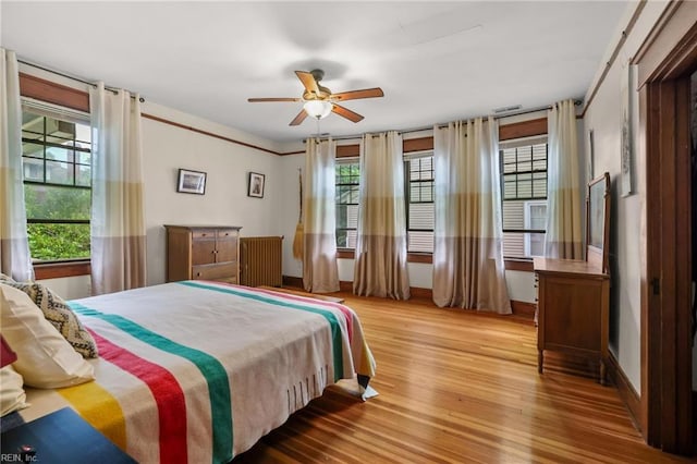 226 Lucile Ave, Norfolk, VA 23504 - bedroom featuring multiple windows, wood finished floors, radiator, and a ceiling fan