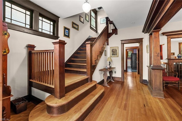 226 Lucile Ave, Norfolk, VA 23504 - staircase with decorative columns, wood finished floors, and baseboards