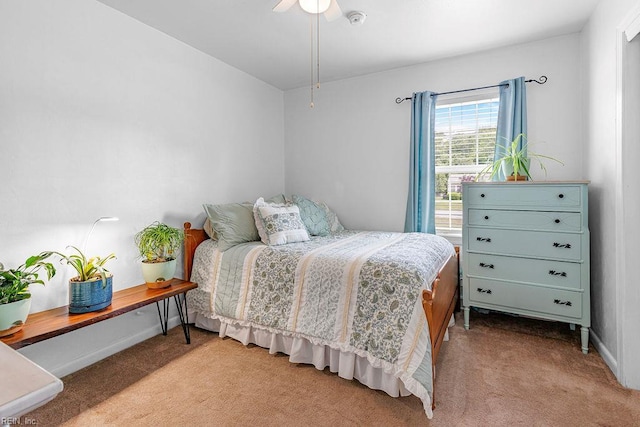 carpeted bedroom with baseboards and ceiling fan