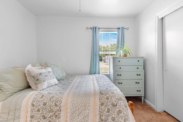 carpeted bedroom featuring baseboards
