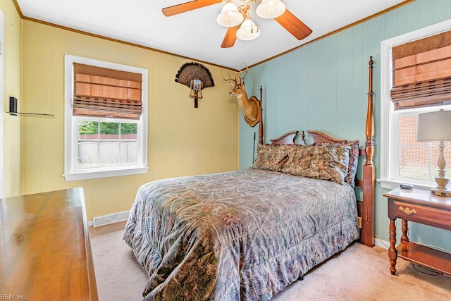 bedroom with carpet, ornamental molding, a ceiling fan, and baseboards