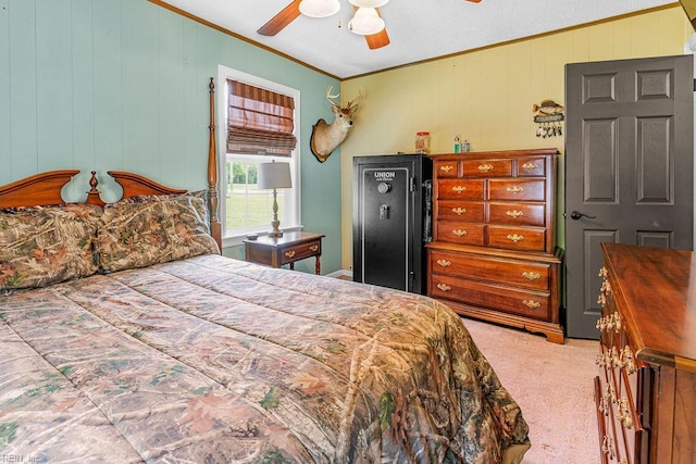 carpeted bedroom featuring crown molding, wooden walls, and a ceiling fan