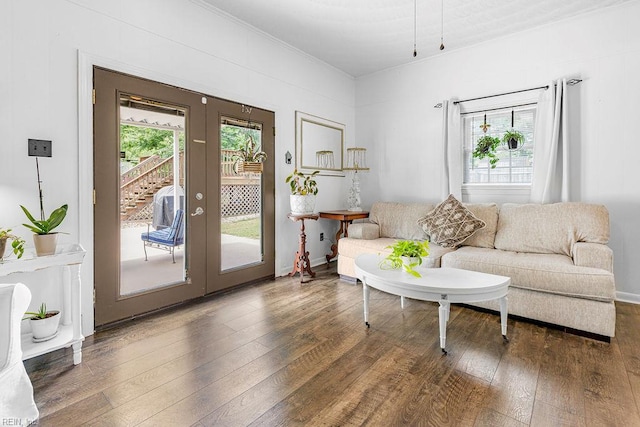 living room featuring french doors, hardwood / wood-style floors, and crown molding