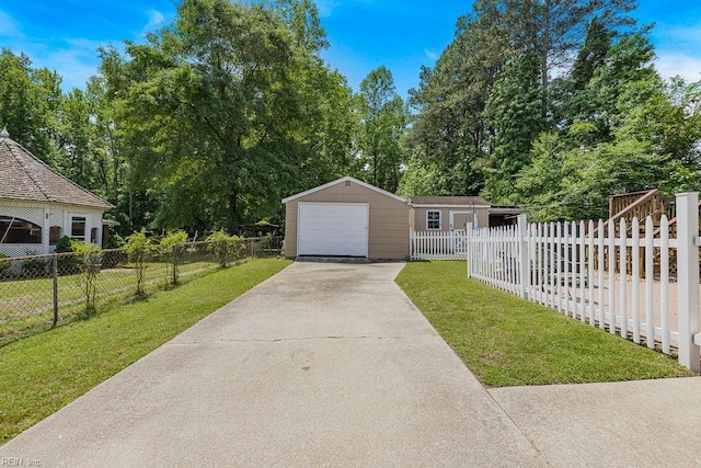 view of front facade featuring concrete driveway, an outbuilding, a garage, and view of wooded area