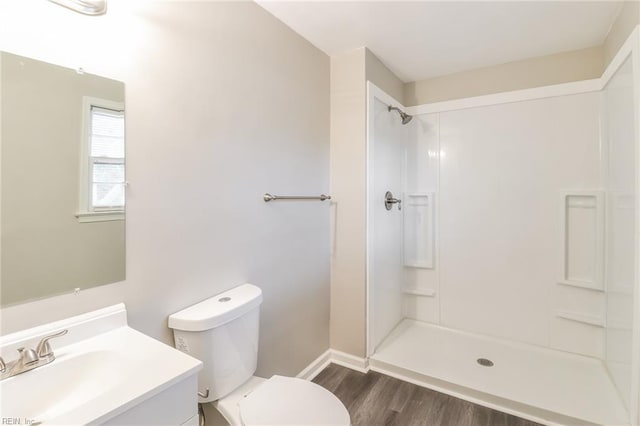3609 Ithaca Trl, Suffolk, VA 23435 - bathroom featuring wood finished floors, toilet, a shower, baseboards, and vanity