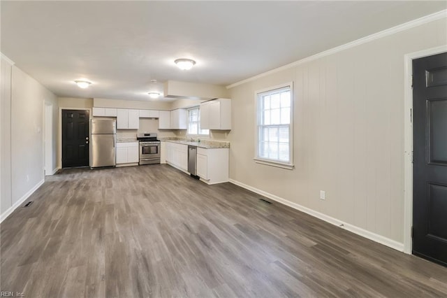 3609 Ithaca Trl, Suffolk, VA 23435 - kitchen with appliances with stainless steel finishes, ornamental molding, baseboards, white cabinetry, and dark wood finished floors