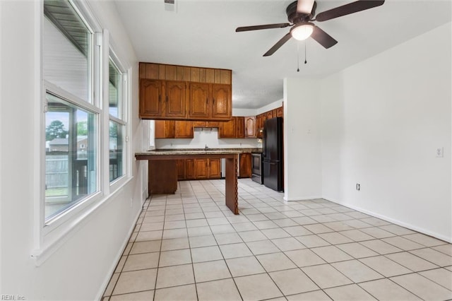 7103 Orcutt Ave, Newport News, VA 23605 - kitchen with freestanding refrigerator, brown cabinets, a ceiling fan, baseboards, and light countertops