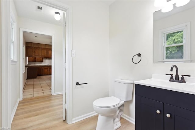 7103 Orcutt Ave, Newport News, VA 23605 - half bathroom featuring toilet, vanity, wood finished floors, and baseboards