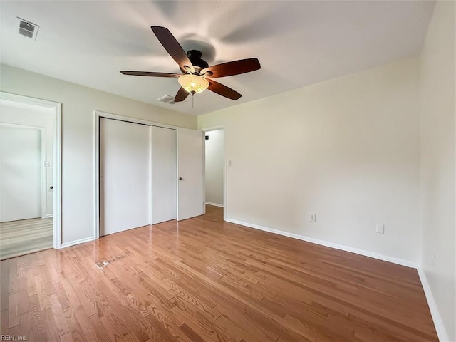 7103 Orcutt Ave, Newport News, VA 23605 - unfurnished bedroom with wood finished floors, baseboards, a closet, and a ceiling fan