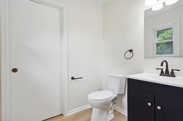 7103 Orcutt Ave, Newport News, VA 23605 - half bath with toilet, vanity, baseboards, and wood finished floors