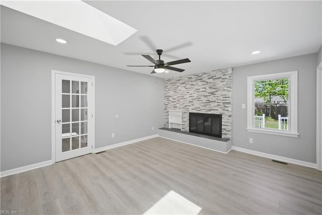 808 Williams Ave, Chesapeake, VA 23323 - unfurnished living room featuring ceiling fan, a skylight, wood finished floors, a fireplace, and recessed lighting