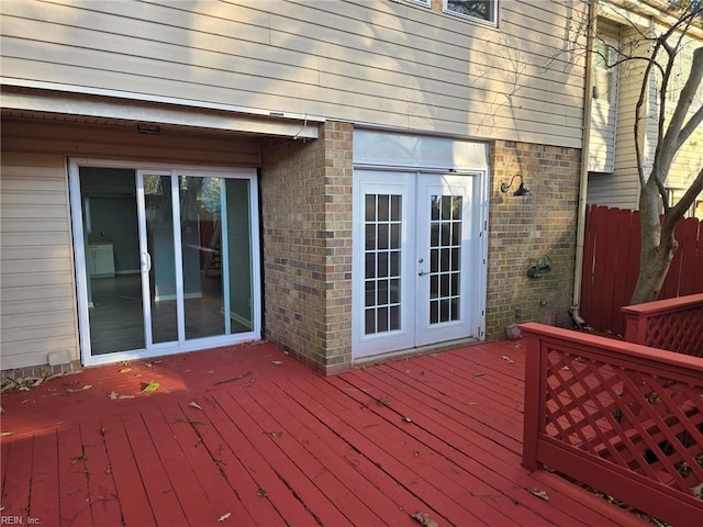 wooden terrace with french doors and fence