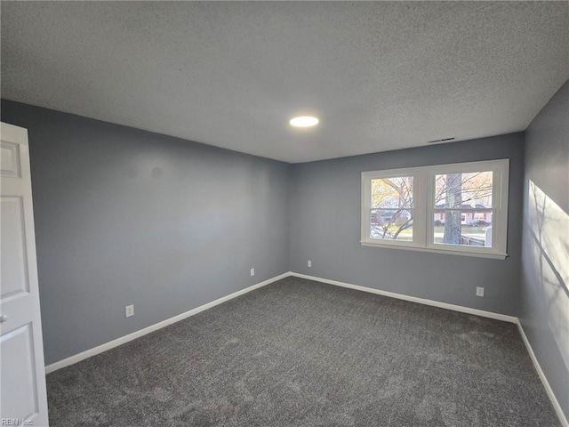 spare room with dark carpet, baseboards, a textured ceiling, and recessed lighting