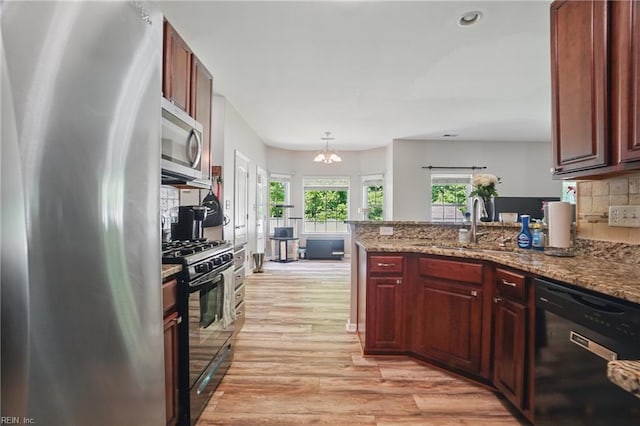 105 Christophers Ln, Hampton, VA 23666 - kitchen featuring black appliances, decorative backsplash, light wood-style floors, a peninsula, and a sink