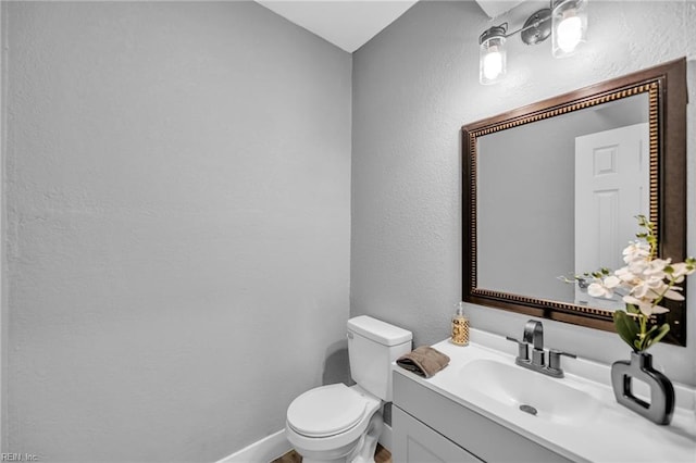 1233 25th St, Newport News, VA 23607 - half bathroom with a textured wall, toilet, vanity, and baseboards