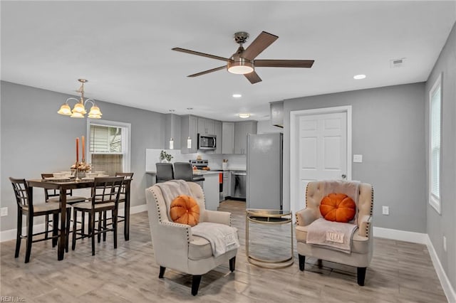 1233 25th St, Newport News, VA 23607 - living area featuring baseboards, a ceiling fan, a chandelier, light wood-type flooring, and recessed lighting