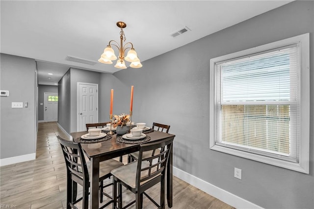 1233 25th St, Newport News, VA 23607 - dining area featuring baseboards, a chandelier, and light wood-style flooring
