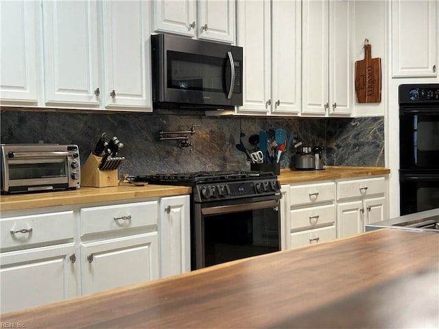 103 Sloop Ct, Williamsburg, VA 23185 - kitchen with gas stove, wooden counters, white cabinets, and tasteful backsplash