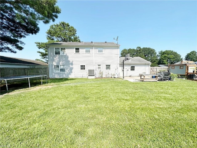 1248 Gladiola Cres, Virginia Beach, VA 23453 - back of property featuring a trampoline, a patio, and central AC