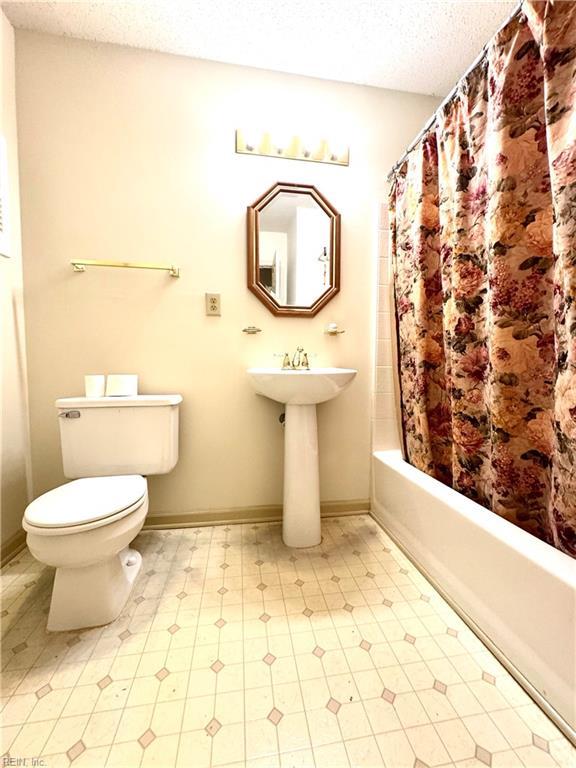 121 Monarch Glade, Yorktown, VA 23692 - full bath featuring a textured ceiling, toilet, shower / bath combination with curtain, and tile patterned floors
