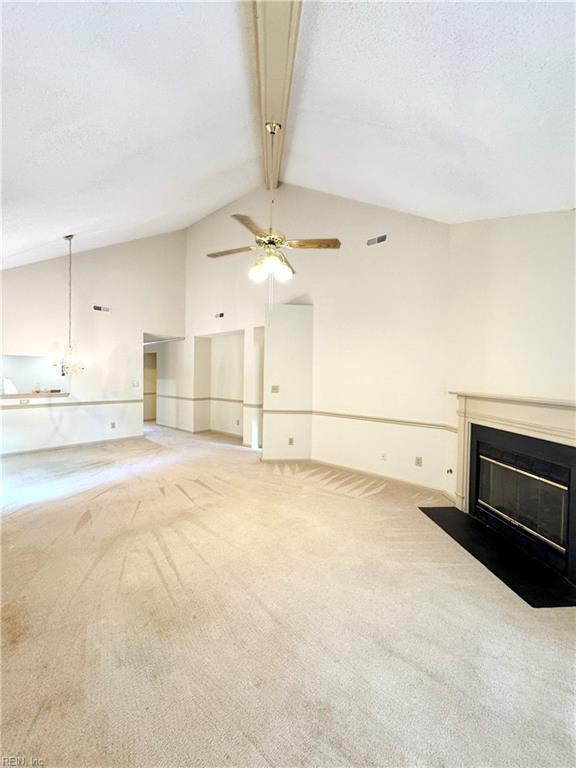 121 Monarch Glade, Yorktown, VA 23692 - unfurnished living room with carpet floors, a fireplace with flush hearth, ceiling fan, beamed ceiling, and high vaulted ceiling