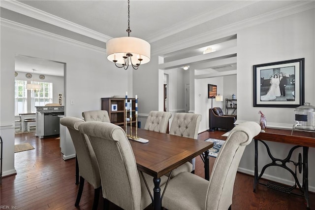 dining area with crown molding, dark wood-type flooring, a chandelier, and baseboards