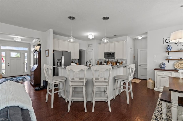 dining space featuring dark wood-style flooring