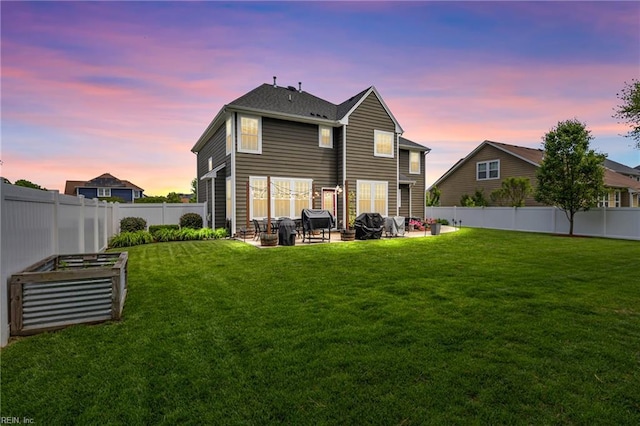 rear view of property featuring a garden and a patio area