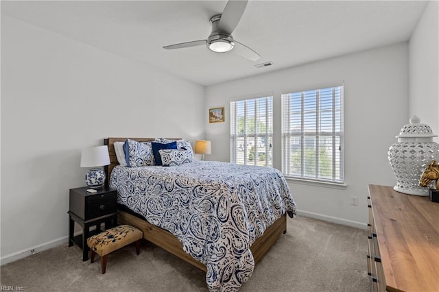 carpeted bedroom with baseboards and a ceiling fan