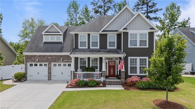 craftsman house featuring a porch, board and batten siding, driveway, a shingled roof, and brick siding