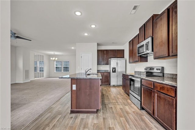 122 American Way, Suffolk, VA 23434 - kitchen with stainless steel appliances, a chandelier, open floor plan, recessed lighting, and stone countertops