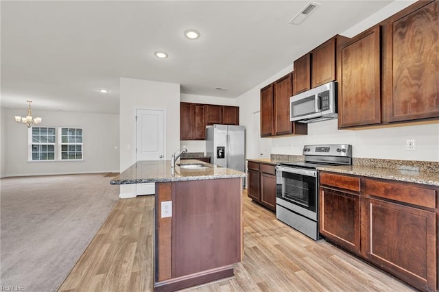 122 American Way, Suffolk, VA 23434 - kitchen featuring stainless steel appliances, a sink, a chandelier, light stone countertops, and recessed lighting