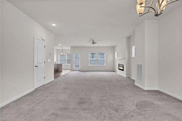 122 American Way, Suffolk, VA 23434 - unfurnished living room featuring a chandelier, carpet flooring, baseboards, a glass covered fireplace, and recessed lighting