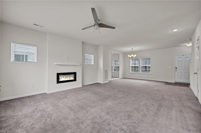 122 American Way, Suffolk, VA 23434 - unfurnished living room with a chandelier, a ceiling fan, a glass covered fireplace, carpet floors, and plenty of natural light